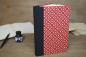 Preview: notebook, hardcover with black canvas spine, red cover paper with black and white geometric pattern